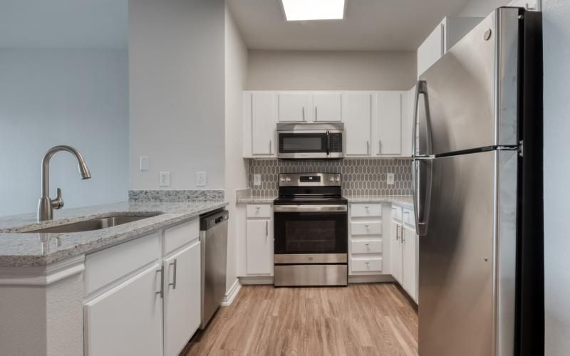 a kitchen with white cabinets