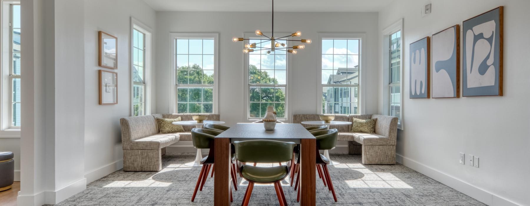 a living room with a table and chairs