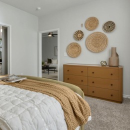 a bedroom with a bed and a fan