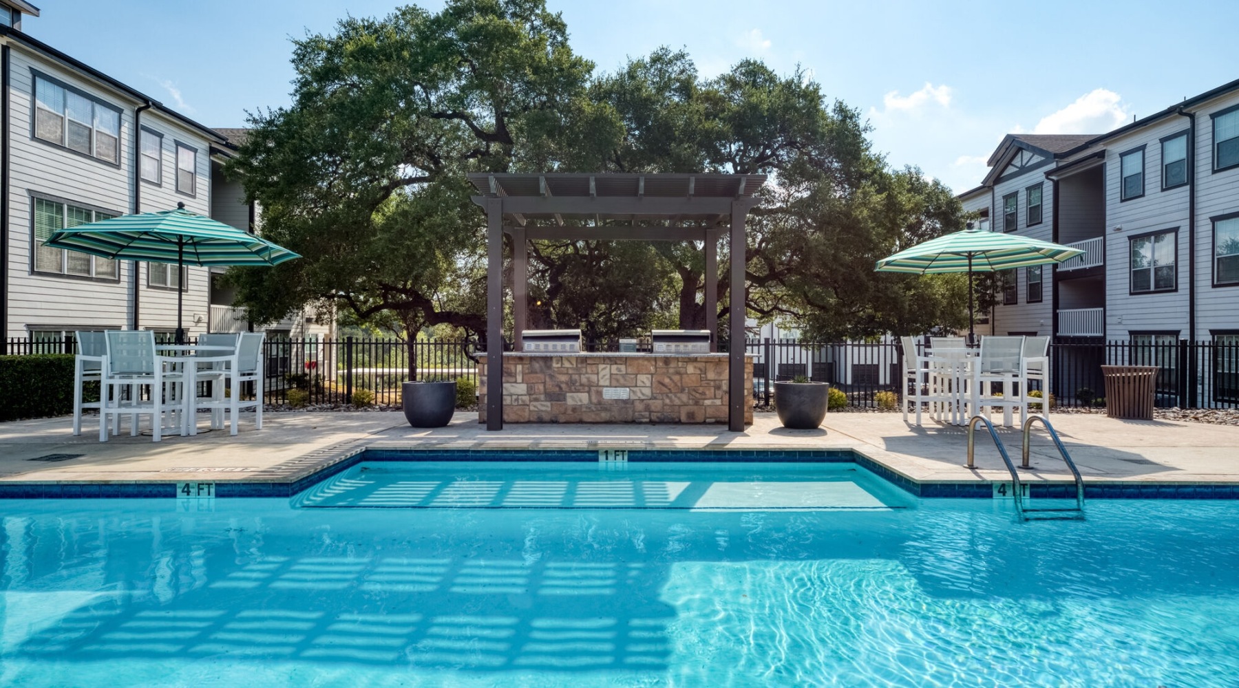 pool with spacious areas and lush landscaping